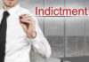 Businessman writing the word 'Indictment' in a modern office