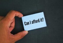 Spring Surge HIDING Brutal Affordability Issues? A hand holding a blue card with the text 'Can I afford it'