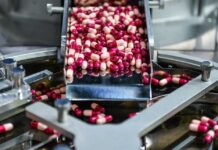 Capsules being processed on a conveyor in a pharmaceutical facility