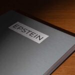 Close-up of a metallic binder labeled 'EPSTEIN'