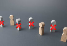 Starbucks SLASHES Even More Jobs — What’s Next? Wooden figures representing people with red crosses indicating exclusion