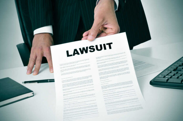 shutterstock_189871757.jpg Businessman holding a lawsuit document in an office