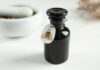 BABY FOOD POISONED — Extortionist Busted Black bottle labeled with a poison warning next to a mortar and pestle