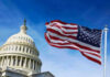 Senators Dock Own Pay — Real Change or Empty Gesture? US Capitol with American flag waving in foreground.