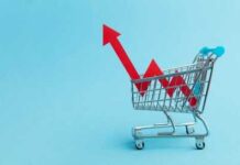 A shopping cart with red arrows indicating growth on a blue background