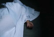 3 Dead in California — What Happened? Hand emerging from under white sheet on dark surface.