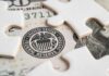 Power Shift: Warsh Takes Reins Close-up of a stack of hundred dollar bills