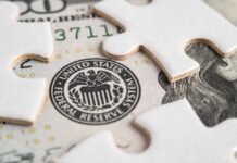 Power Shift: Warsh Takes Reins Close-up of a stack of hundred dollar bills