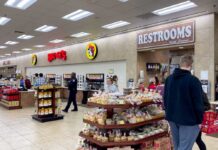 Buc-ee’s Expansion Blitz Stuns Rivals Interior of a Buc-ee's convenience store with snack displays and a restroom sign