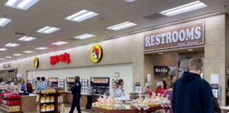Interior of a Buc-ee's convenience store with snack displays and a restroom sign