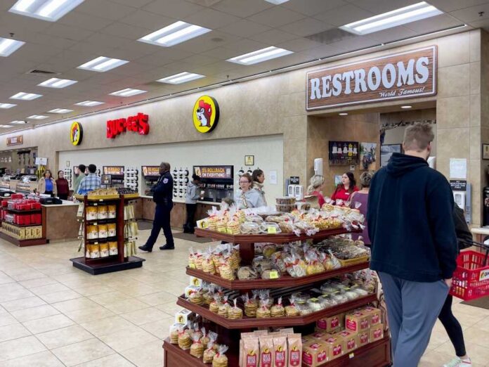 shutterstock_2373499871.jpg Interior of a Buc-ee's convenience store with snack displays and a restroom sign