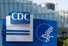 Cruise Ship Virus Panic — CDC Pushback Signage of the CDC building displaying its name and logo