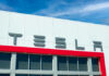 Tesla building with logo against blue sky