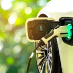 $9 BILLION ELECTRIC VEHICLE BET CRASHES Electric car charging at a charging station.