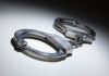 Livestreamer Faces Murder Charge Close-up of metallic handcuffs on a light surface