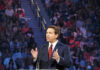 DeSantis Declares Victory Person speaking at podium in front of large audience.