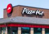 Exterior view of a Pizza Hut restaurant with a prominent logo