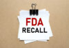 Recall Alert: FDA Slaps Highest Risk A notice labeled 'FDA RECALL' clipped to white papers on a brown background