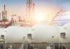Gas storage tanks in an industrial facility during sunrise