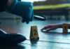 GPS Bombshell Impacts Potential Murder Case A detective examining evidence at a crime scene with markers on the floor
