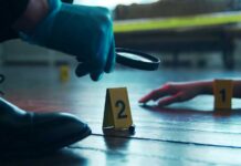 GPS Bombshell Impacts Potential Murder Case A detective examining evidence at a crime scene with markers on the floor