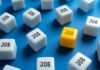Jobs Number Stuns Forecasters A yellow cube with the word 'JOB' surrounded by white cubes with the same word on a blue background