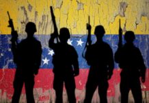 Trump’s Deadly Mission: Socialist Assist? Silhouettes of soldiers in front of the Venezuelan flag