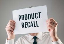 Recall: Hidden Fire Threat Revealed Person holding a sign reading product recall
