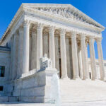Supreme Court Nukes 91-Year Power Shield Supreme Court building with columns, fountain, and statue.