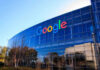Google logo on office building exterior glass.