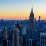 Rooftop Killers Lurk Over Manhattan? Empire State Building at sunset over Manhattan skyline