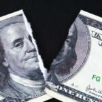 Paying More, Bringing Home Less A torn hundred dollar bill featuring Benjamin Franklin