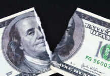 Paying More, Bringing Home Less A torn hundred dollar bill featuring Benjamin Franklin
