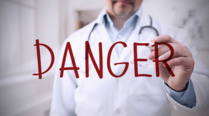 Epidemic,Alert.,Doctor,Writing,Word,Danger,On,Virtual,Screen,In Doctor writing danger on transparent screen