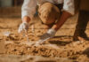 Ancient Rings Unearthed, Zodiac Message Stuns Archaeologist carefully excavating fossils in sandy soil