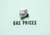 Gas Price PLUNGE Flips Inflation A bundle of cash next to the words 'GAS PRICES' on a light green background