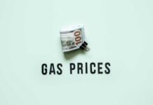 Gas Price PLUNGE Flips Inflation A bundle of cash next to the words 'GAS PRICES' on a light green background