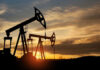 FTC–DOJ Target Big Oil Gaming Oil pump jacks silhouetted against sunrise sky