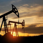 FTC–DOJ Target Big Oil Gaming Oil pump jacks silhouetted against sunrise sky