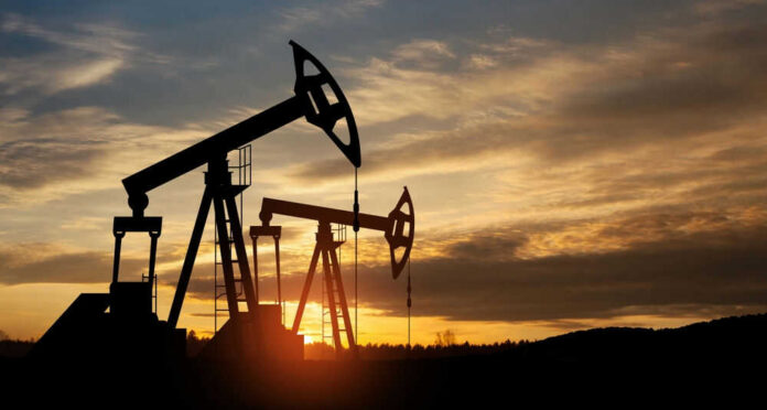 shutterstock_2283367131 Oil pump jacks silhouetted against sunrise sky