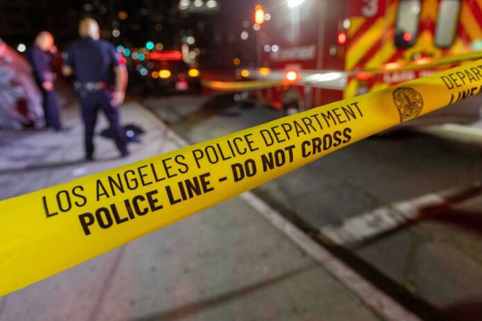 shutterstock_2312457803-1 Los Angeles police tape at night crime scene.
