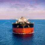 Oil tanker ship on open sea at dusk
