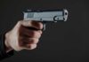 Deadly Chaos at Festival: Gunfight Erupts Hand holding a semi-automatic pistol pointed forward