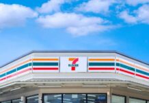 convenience store exterior with colorful striped signage under blue sky