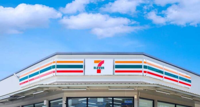 convenience store exterior with colorful striped signage under blue sky