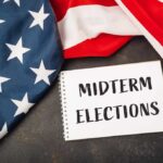 Trump Turns Midterms Into Dallas Showdown American flag and a notebook with 'MIDTERM ELECTIONS' written on it