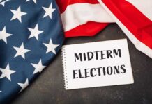 Trump Turns Midterms Into Dallas Showdown American flag and a notebook with 'MIDTERM ELECTIONS' written on it