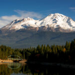 Snow-covered mountain peak partially obscured by clouds