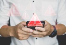Algorithmic Bouncer Locks Out July 4 Guests Hands holding a smartphone with warning icons overlay