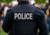 VIDEO: Romo Stop Explodes – Refusal Twist Stuns Cops Back view of a police officer wearing a uniform with 'POLICE' displayed